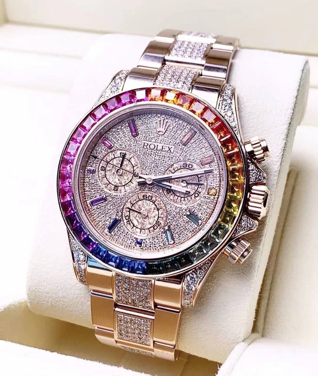 飞越彩虹之巅---劳家彩虹圈迪通拿 铂金眼 Cal.7750机械计时， “二代彩虹迪通拿”表壳、表带采用316L精钢材质打磨，每个壳套全程CNC处理所有细节，再经过人工流程润饰，打磨和检测做工精细，圈口角度与宝石大小数量颜色跟专柜彩虹渐变效果一致，玻璃使用蓝宝石透彻效果镜面，机芯采用7750全自动计时机械机芯，表带分别全人工镶钻精钢实心表带OR进口氟橡胶表带，配备防止意外打开的蚝式保险扣，佩戴舒适，操作也十分简便！ 这款腕表最大的特点莫过于表圈的七彩宝石和字面的十二个彩钻刻度，彩色渐变效果一一对应，这些宝石闪耀着红橙黄绿青蓝紫等斑斓的色彩，恰似添上曼妙多姿的变化色彩，劳力士精心挑选了玲珑精巧的宝石，并组合镶嵌在了一起，为腕表赋予了奇异的光彩。