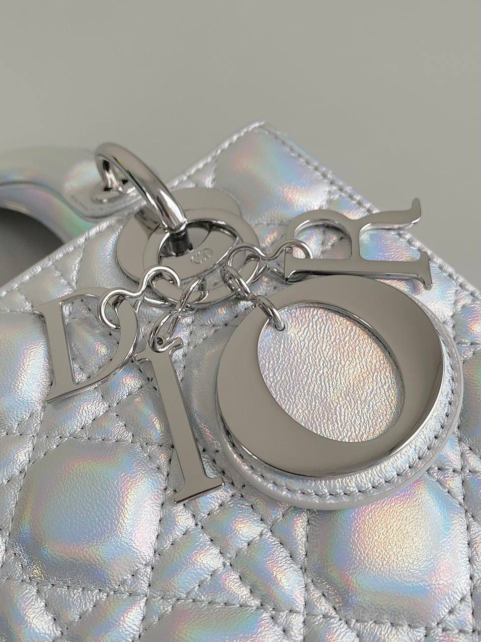 🈶镭射银 𝗗𝗜𝗢𝗥 𝗟𝗮𝗱𝘆羊皮四格银扣 快！快！快！很少见有这么特色的包 Bing灵动炫目大胆的科幻视觉冲击太震撼 整个包身珠光呈镭射效果，犹如彩虹般 很是惊艳！配银色金属更有张力，好抢眼啊 优雅与炫酷的反差碰撞，也就只有它独具一格 拿到手你们一定要多背出去走走 它实在是美到过分了！！ 进口原厂羊皮➕全钢五金 （配8个五金图案 全套包装） 20×16.5×8cm 4123m