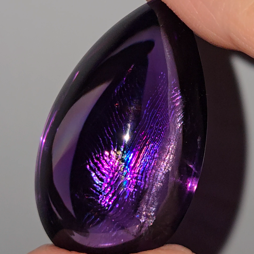 Amethyst cabochon with rainbows, fingerprint inclusions - A30