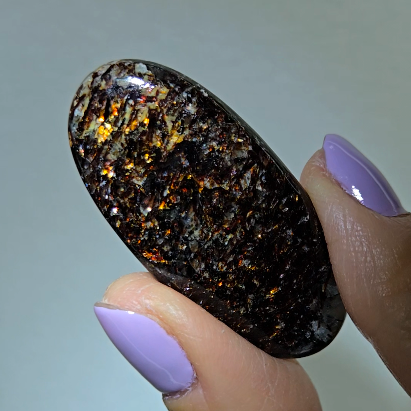 Astrophyllite cabochon with red, golden, bronze inclusions - AST25 