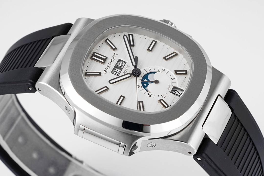 新晋 “钢王”百达翡丽Ref.5726/1A Nautilus系列年历胶带款腕表亮相！🤩😍 鹦鹉螺全系列一贯设计的旋窗造型表壳，与正品工艺一致的采用锻纹修饰和抛光工艺处理构成鲜明对比，1:1还原了正品每个细节。盘面深邃蓝色并装饰有水平横纹浮雕图案颜色从中央向四周扩散，星期月份双视窗和日期窗黑字白底辨识度高，24小时显示盘附带月相十分高雅，整体给人的感觉是独特又优雅，是最美的鹦鹉螺之一。背面蓝宝石镜面，搭载PPF独家研发的324S QA LU 24H/303自动一体机械机芯，21K的大金陀让上链效率更高，红宝石轴承日内瓦纹下方的鱼鳞纹精致无比，机芯打磨依旧是业内标杆级别。首款年历腕表能正确辨别出大小月，每年只需要在3月1日调节一次日期即可。 表带升级为橡胶款更显运动时尚感，一年四季均可舒适佩戴，驾驭更多风格穿搭，新晋 “钢王”将成这个寒冬腕表的不二之选。