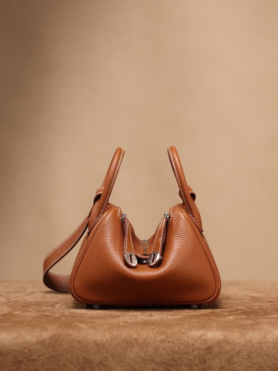 Hermes 爱马仕 Lindy Mini 19cm 金棕色银扣👜✨ Lindy 独家渠道货 独家欧洲原厂皮原厂五金组装的ZP尾单货 尺寸：19*12.5*9cm Lindy是采用原厂的正品TC皮，什么是TC皮？ 爱马仕专用的clemence,简称tc皮，是Hermes最受欢迎的皮革之一，颜色会比Togo少一些，但是纹路比Togo细腻，含油更高，更软，因此稍稍有些下垂感的特点。