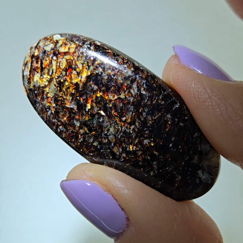 Astrophyllite cabochon with red, golden, bronze inclusions - AST25 