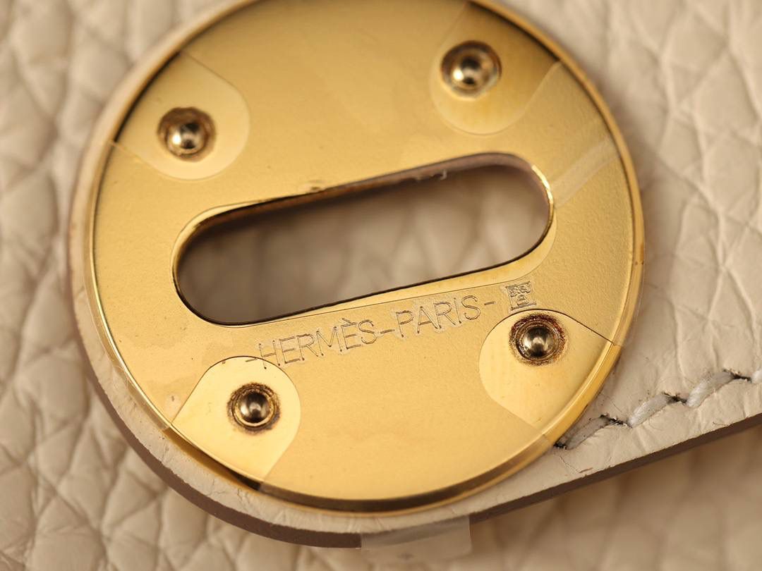 Hermes 爱马仕 Lindy 26cm 奶油白金扣👜✨ 尺寸：26*18*14 cm 奶油白真的实物很漂亮，YYDS😍 五金介绍，拉链尾部的"H"是刚好的正方形，而且每笔都是很直，菱角分明，表明平整 图二至六图的的五金四个小螺丝是人工围着这四个小圆点边雕琢上去的，而且小螺丝这点的周围圈是有孤独深的圆形，这点很多人都不知道，这个是符合正品工艺的 拉链是纯原装金扣的RIRI拉链 所以在五金方面我们拿捏的死死的 无人能敌 🤟🏻 渠道货是注重任何一个细节的 做到任何人都做不到的点 这就是天花板😍💯👍