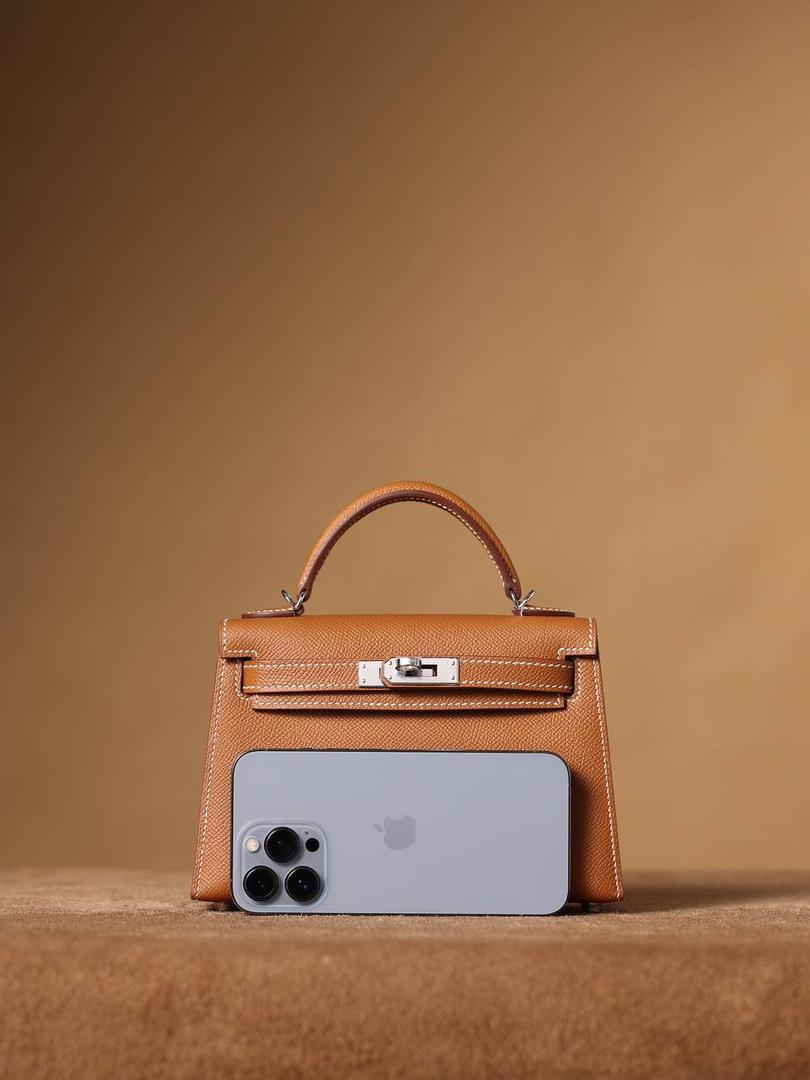 HERMES 爱马仕 Mini Kelly 二代👜✨ Mini Kelly 二代 金棕银扣 高清实拍图 尺寸：19*12*6cm Hermès爱马仕是世界著名的奢侈品品牌，1837年由Thierry Hermès创立于法国巴黎。 爱马仕早年以制造高级马具起家，迄今已有180年的悠久历史。 其整个品牌从整体到细节以及专卖店，都弥漫着浓郁的以马文化为中心的深厚底蕴🎀