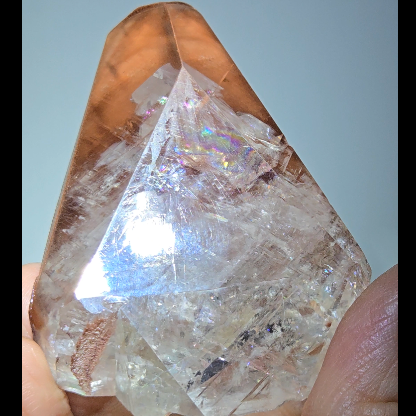 Red diamond calcite point with rainbows - CC54