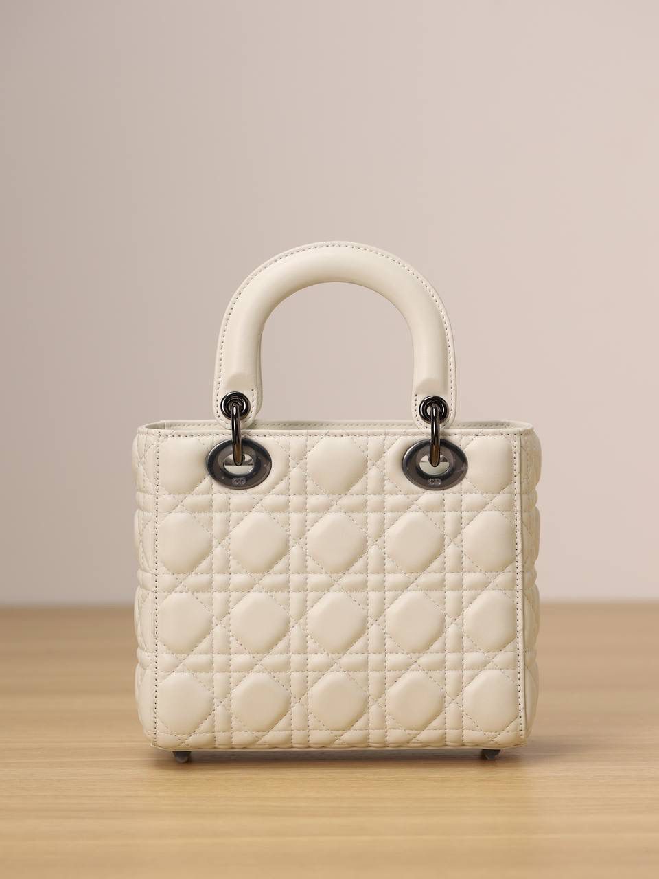 小号 LADY DIOR MY ABCDIOR 手袋 奶白色羊皮革藤格纹 独家渠道货 四格戴妃包白色羊皮枪扣 尺寸：20 x 17 x 8 厘米 这款 Lady Dior My ABCDior 手袋彰显 Dior 经典标识。 款式时尚精致，是一款经久不衰的单品。 采用奶白色羊皮革精心制作，搭配藤格纹缉面线，精良的绗缝质感显露无遗。 饰以金属覆层D.I.O.R.吊饰，为醒目的轮廓增添一分灵动💕💕