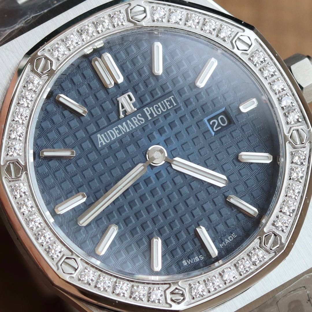 🚀原单AUDEMARS PIGUET爱彼 皇家橡树系列67女士石英腕表 独家原版拆解开模 所有配件均可原版互换使用，搭载原装瑞士F04111石英机芯。走时精准！全程CNC打磨，多次校对调整版型，棱角分明。表壳直径33MM,多边形状表圈与表壳精密相合，表圈以六边形螺丝栓固定在表壳上（圈口镶嵌精美施华洛世奇钻，璀璨夺目）表带链节精致规整，链节经过上百次细致的打磨处理，呈现出完美的纹理。折叠式表扣开合简单，佩戴方便。腕表表耳处呈弯折状，可以保证腕表与腕部更加贴合。表盘镌刻“Grande Tapisserie”大方格纹装饰，搭配荧光立体时标和皇家橡树指针，宽大的指针和时标让读时简单清晰。三点位置日期显示窗口，以阿拉伯数字显示。腕表为密闭表底，表底上镌刻皇家橡树系列的英文名称“Royal Oak”字样✨🔥