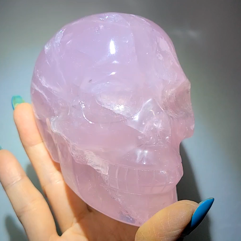 Rose quartz skull with star flash asterism and rainbows.