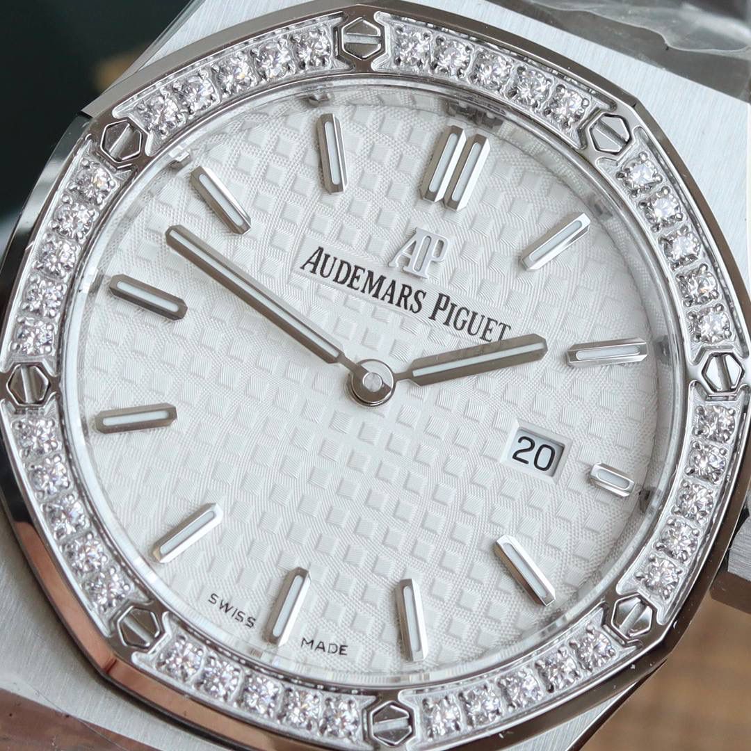 🚀原单AUDEMARS PIGUET爱彼 皇家橡树系列67女士石英腕表 独家原版拆解开模 所有配件均可原版互换使用，搭载原装瑞士F04111石英机芯。走时精准！全程CNC打磨，多次校对调整版型，棱角分明。表壳直径33MM,多边形状表圈与表壳精密相合，表圈以六边形螺丝栓固定在表壳上（圈口镶嵌精美施华洛世奇钻，璀璨夺目）表带链节精致规整，链节经过上百次细致的打磨处理，呈现出完美的纹理。折叠式表扣开合简单，佩戴方便。腕表表耳处呈弯折状，可以保证腕表与腕部更加贴合。表盘镌刻“Grande Tapisserie”大方格纹装饰，搭配荧光立体时标和皇家橡树指针，宽大的指针和时标让读时简单清晰。三点位置日期显示窗口，以阿拉伯数字显示。腕表为密闭表底，表底上镌刻皇家橡树系列的英文名称“Royal Oak”字样✨🔥