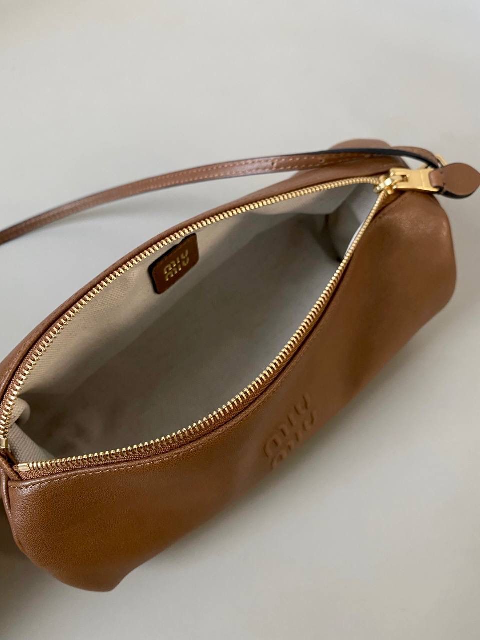 🈶焦糖色 𝗠𝗶𝘂𝗠𝗶𝘂迷你小圆筒 小小一只，太可爱了啦！ 头层Nappa(纳帕)羊皮用料 柔软细腻有光泽，透出高级的质感 整个包都好软糯手感超治愈的！！ 自重非常非常轻！日常还能装不少 肩带长度可以调，冬天大衣能轻松驾驭 小包闭眼冲就是了，四季可用 21.5×9×9cm #F0055m