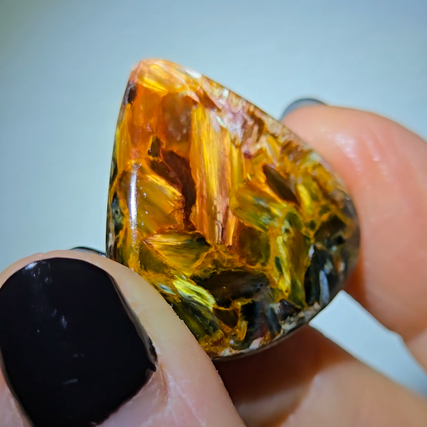 Red, gold, and blue pietersite cabochon from Namibia - PT7
