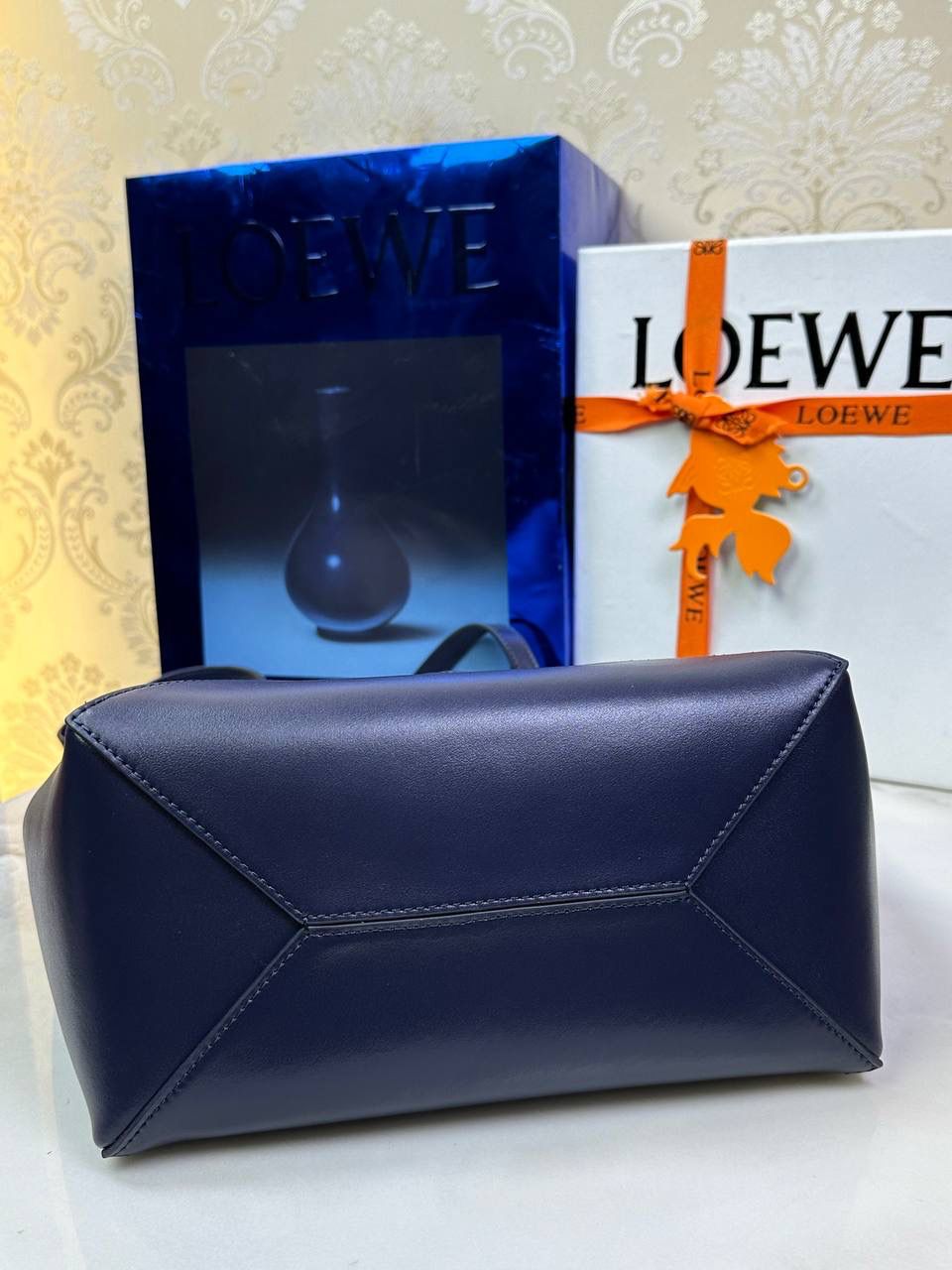 *𝐏𝐮𝐳𝐳𝐥𝐞 𝐅𝐨𝐥𝐝折叠手袋👜*（深邃蓝） ——全新【𝗡𝗘𝗪】升级‼️ 延续经典𝙋𝙪𝙯𝙯𝙡𝙚的标志性几何裁剪设计，新晋顶流🅰️𝙋𝙪𝙯𝙯𝙡𝙚 𝙁𝙤𝙡𝙚 𝙏𝙤𝙩𝙚以折纸包为灵感，升级成🉑完全折叠‼️的结构，立体与平面任意切换，出差旅行🧳必备单品。小牛皮材质轻且柔软，𝐌𝐢𝐧𝐢尺寸搭配一条可拆卸式肩带，手提，肩背，斜挎多样化背法✨ 尺寸：𝟐𝟓.𝟓-𝟏𝟒.𝟓-𝟑𝟏.𝟓cm 款号：052316