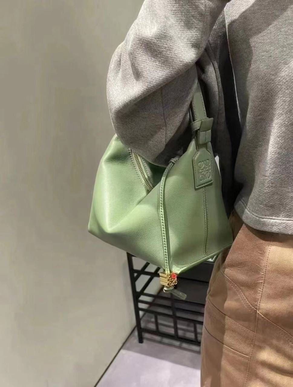 * 小号纳帕牛皮 𝐂𝐮𝐛𝐢 手袋👜 颜色：竹青绿 尺寸：21-17-13cm（中部最宽24cm） 编码：062207 Cubi手袋是一款宽敞的手拎肩包，带有牛皮革底座和柔软的包身。拉链头上的心形骰子五金🎲。肩背或手拿*可调节肩带*拉链封口，牛皮革拉链头*内部插袋*人字纹棉纺布内衬里*Anagram压纹