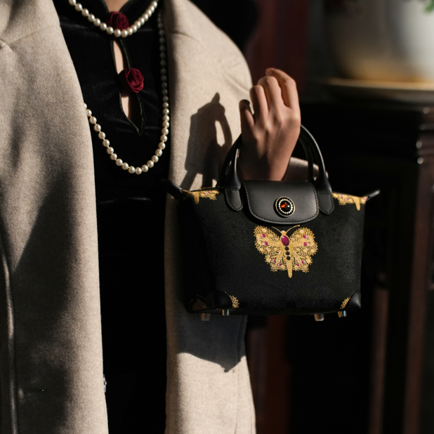 宋錦∞黑金紅蝴蝶牛皮小號手袋。上久楷