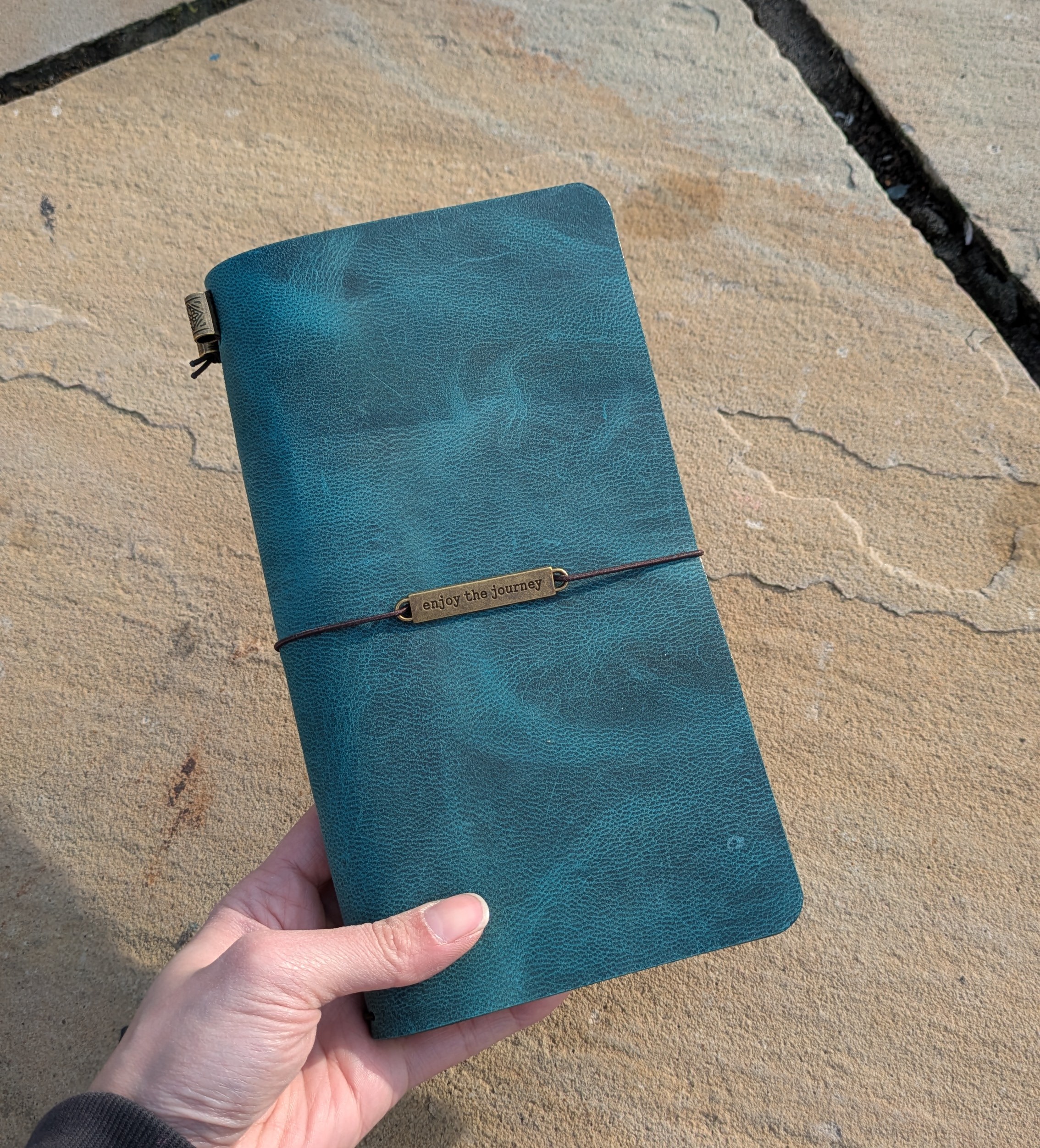 Hand-finished teal crazy horse leather, marked by natural pull-up lightening and organic marbling |