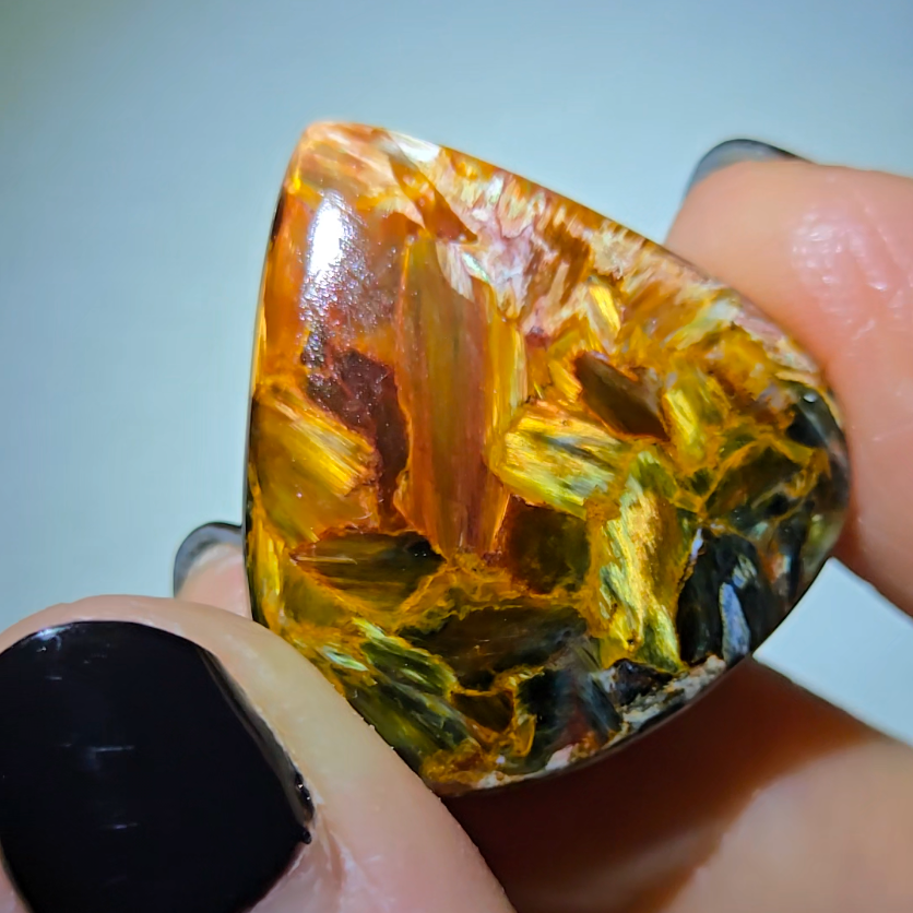 Red, gold, and blue pietersite cabochon from Namibia - PT7