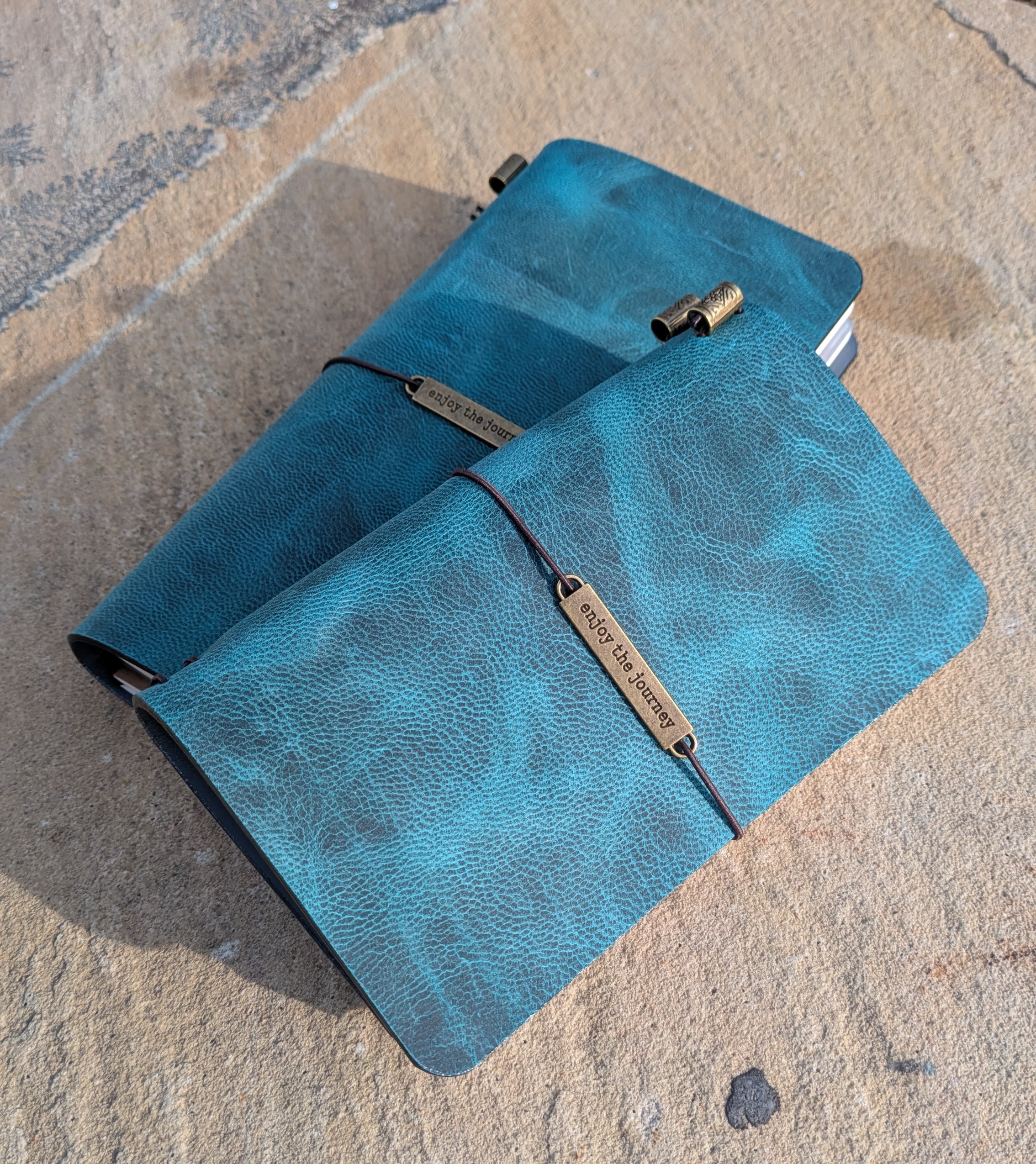 Hand-finished teal crazy horse leather, marked by natural pull-up lightening and organic marbling |
