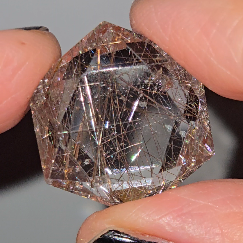 Rose gold rutiles in faceted quartz - RT257