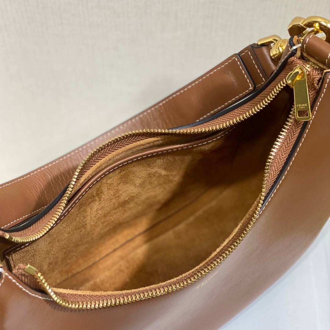 🔥大货实拍图 𝗖𝗘𝗟𝗜𝗡𝗘 ♥ 𝗔𝗩𝗔 𝗦𝗧𝗥𝗔𝗣 独特新月包型打造摩登格调，醒目金属圆环与考究皮革饰带点缀，匠心与巧思交织，定格别致意趣造型。型号：196923 尺寸：24*13*7cm