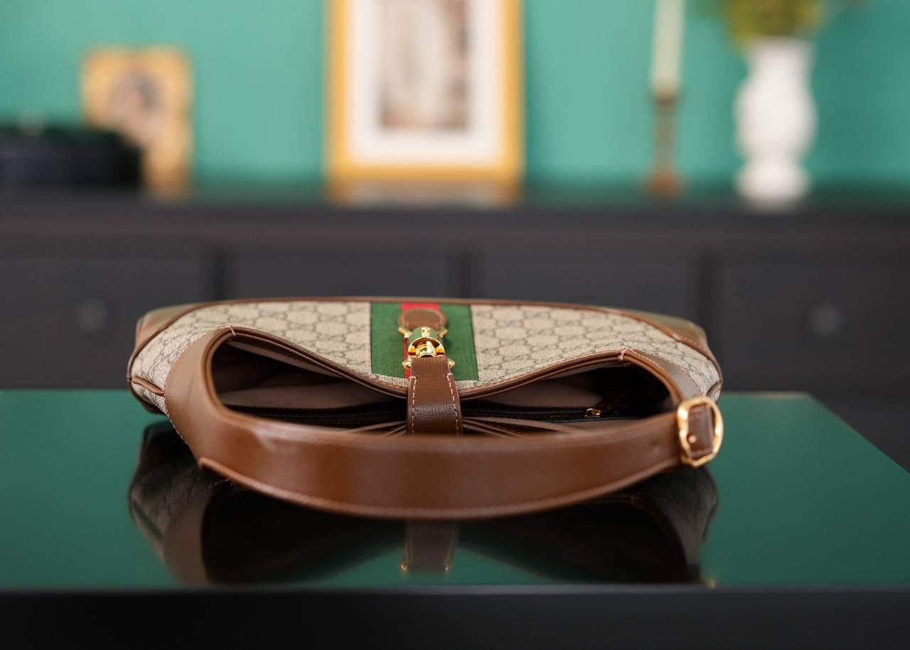 🥯GG Jackie 1961系列小号手袋 棕色28cm 正品售价,200 经典𝙅𝙖𝙘𝙠𝙞𝙚是爱豆们最近的心头好 绿红织带复古设计 将60年代的气息与现代的时尚融合交汇 不仅让人感受到浓郁的复古美感， 还多了时尚潮流的气息，结合起来真的是非常赞！！！ 两条肩带设计，腋下背单肩背多风格背法~ 官方款号 636706 尺寸：28x19x4.5cm