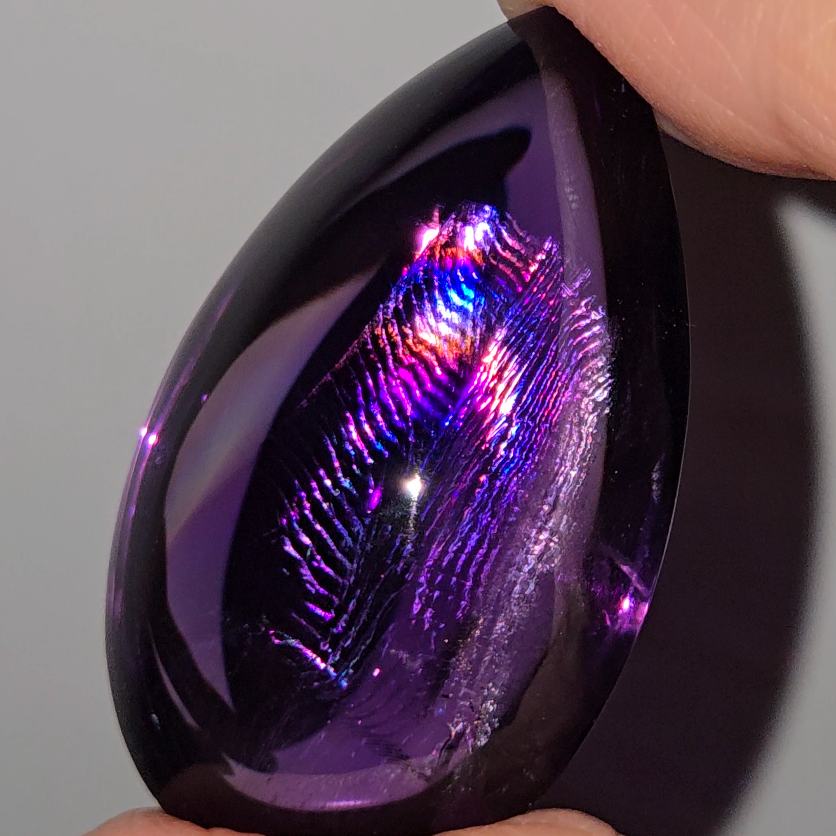 Amethyst cabochon with rainbows, fingerprint inclusions - A30