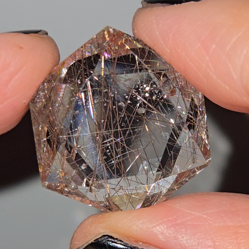 Rose gold rutiles in faceted quartz - RT257