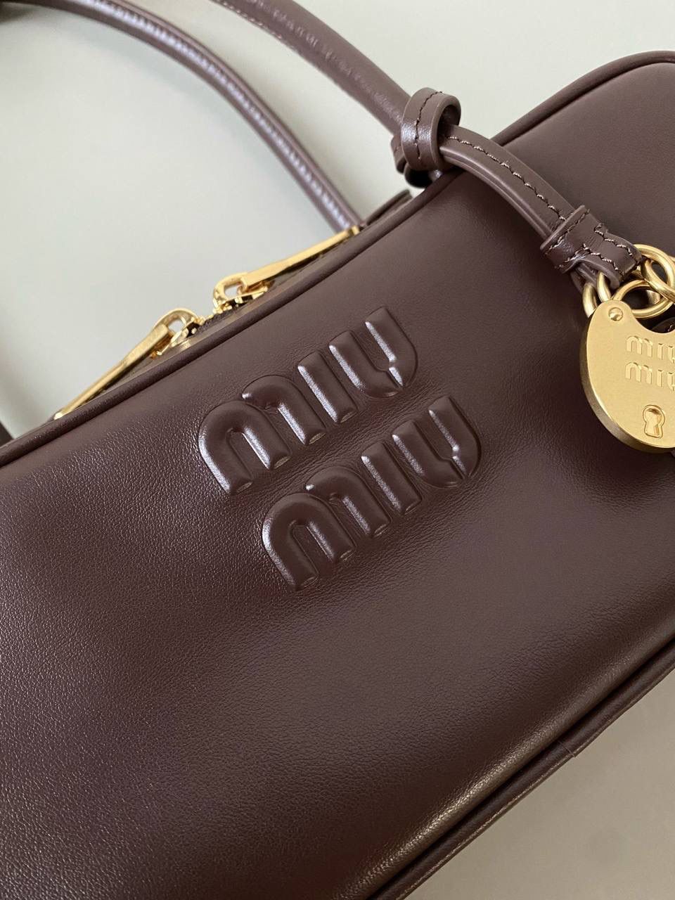 🈶石南木色 𝗠𝗶𝘂𝗠𝗶𝘂保龄球| 吊饰版 说是公文包.更是保龄球！ 虽倆者都早已大火全网时髦圈哈哈 今年这只长手柄保龄球能买到就是赚到咯！ 细长的手柄整体更秀气了 还送了一串吊饰 是一把锁头还有一个爱心， 上面都有logo刻印很精致也很厚重 宝子们再也不愁买挂饰啦！ 28×11.5×8cm #F0010m