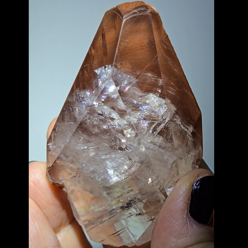 Red diamond calcite point with rainbows - CC54