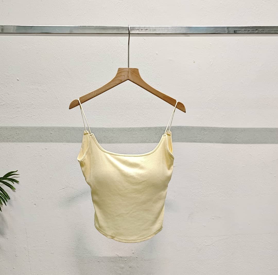2510 Two camisole tops in black and grey hanging on wooden hangers.