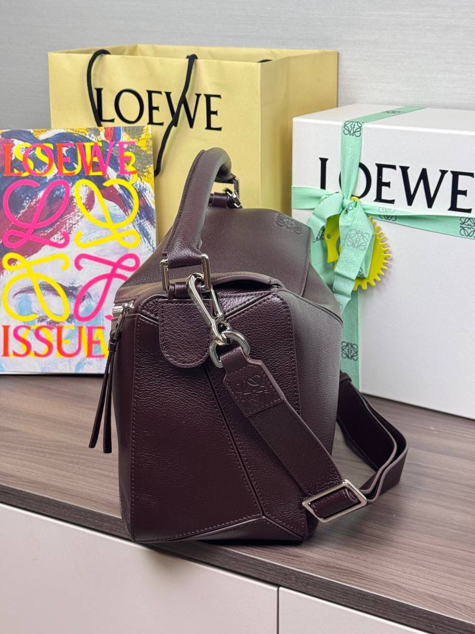 🎈【全钢】大号鹿皮𝘗𝘶𝘻𝘻𝘭𝘦* ——【👉🏻牛血色到货✅】 尺寸：𝟑𝟐.𝟓-𝟏𝟒.𝟓-𝟐𝟑.𝟓𝐜𝐦 编码：260403 【配全套包装】 ❤️经典拼图系列•不规则立体几何设计•最具辨识度的立体廓形和几何美学•顶级进口皮搭配德国沙菲线•独家定制五金•𝗬𝗞𝗞拉链拉头。 ❤️该款大号采用鹿皮革制成•绒面内里•搭配一条可拆卸可调节的皮肩带•肩背斜挎或手提多样化背法。