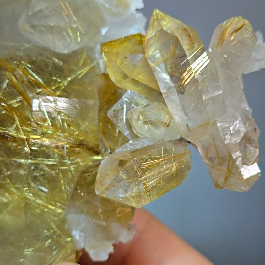 Golden titanium rutiles on black hematite in quartz cluster - RT1443