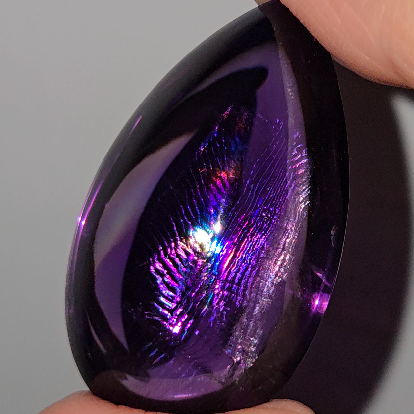 Amethyst cabochon with rainbows, fingerprint inclusions - A30