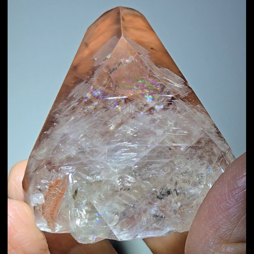 Red diamond calcite point with rainbows - CC54