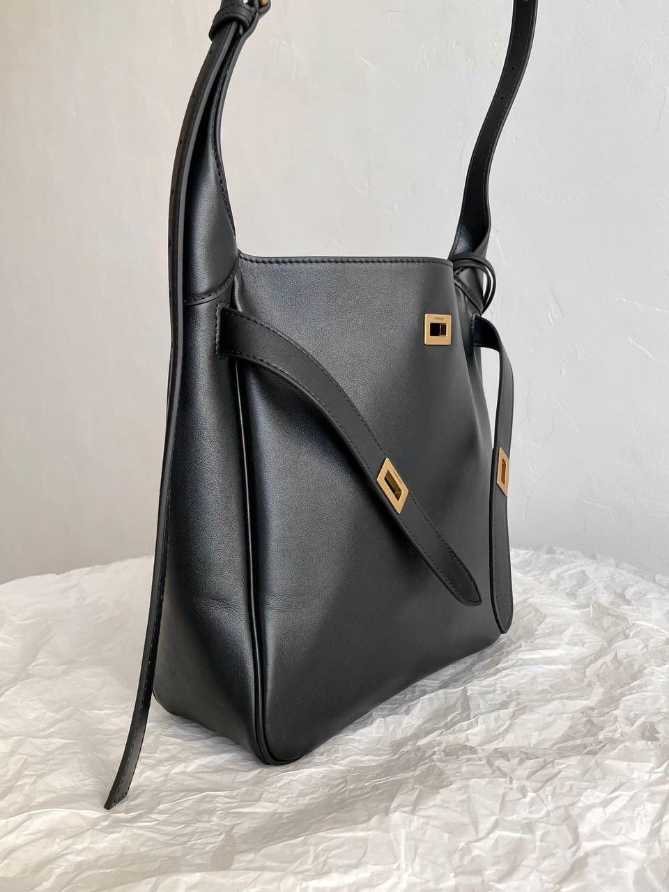 爆款🔥小号🖤 ba1enciaga bel air hobo桶包 beiair➕rodeo，大热当道 一整个系列都火爆了，一只比一只热门 半定型的水桶包超有态度 它的皮是有点厚度又软乎的 所以整个包都散发着慵懒和不羁的感觉 而且设计元素不拖沓繁琐 完全可以无脑搭配 现在的通勤人员也是吃得太好了吧 能有这么时髦的托特包来背！ 什么电脑水杯统统往里扔就对了 肩带可长可短，腋下背斜挎背都ok 两个尺寸任君选择，果断冲！！ 小号：26.9×25.9×9.9cm811018m 大号：43.9x39.8x14.9cm