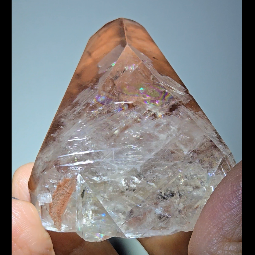 Red diamond calcite point with rainbows - CC54