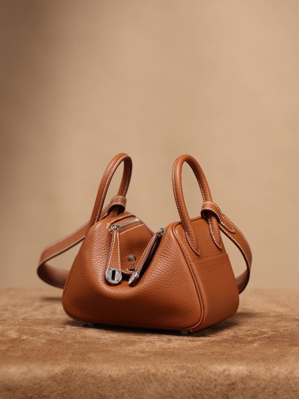 Hermes 爱马仕 Lindy Mini 19cm 金棕色银扣👜✨ Lindy 独家渠道货 独家欧洲原厂皮原厂五金组装的ZP尾单货 尺寸：19*12.5*9cm Lindy是采用原厂的正品TC皮，什么是TC皮？ 爱马仕专用的clemence,简称tc皮，是Hermes最受欢迎的皮革之一，颜色会比Togo少一些，但是纹路比Togo细腻，含油更高，更软，因此稍稍有些下垂感的特点。