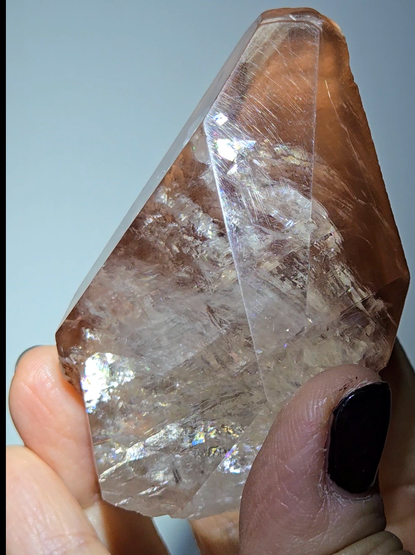 Red diamond calcite point with rainbows - CC54