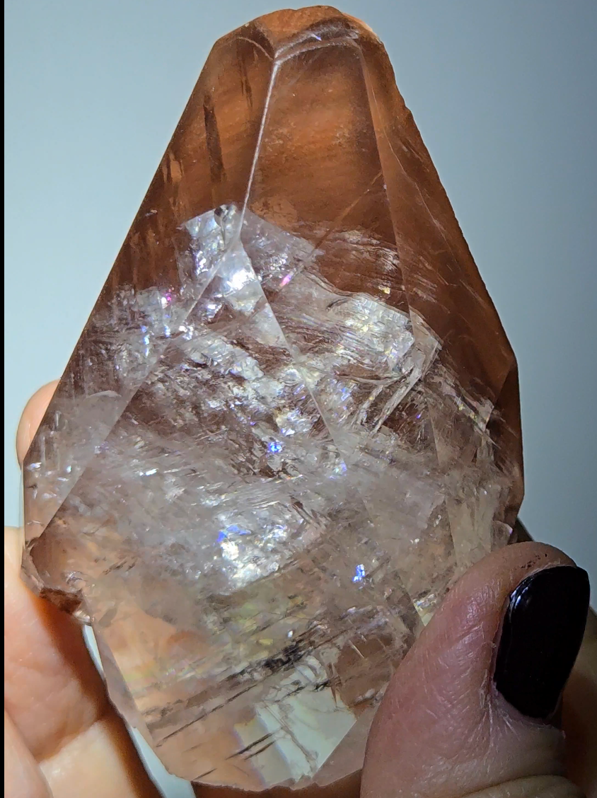 Red diamond calcite point with rainbows - CC54
