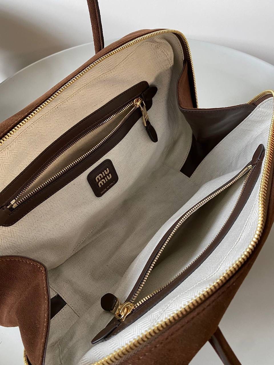 🈶可可棕 𝗠𝗶𝘂𝗠𝗶𝘂24秋冬公文包 今年棕麂皮系列大人气啊！ 深深的巧克力色，满满秋冬味儿～ 绒面皮每年都会有，但是！！今年这股风刮的特别猛 从秀场到ins博主穿搭，或者线上门店 几乎都有麂皮元素！ 西装款 夹克 风衣 鞋子 包括包包等 延续去年美拉德色系的颜色， 今年的颜色各种各样，有深有浅 但我唯爱咱miu家的这个巧棕色 绝对秋冬氛围感里，最“增质感”的时髦单品！ 23×34×10cm #F0020m