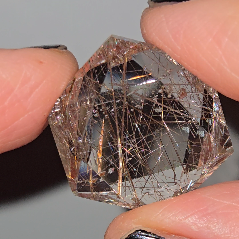 Rose gold rutiles in faceted quartz - RT257