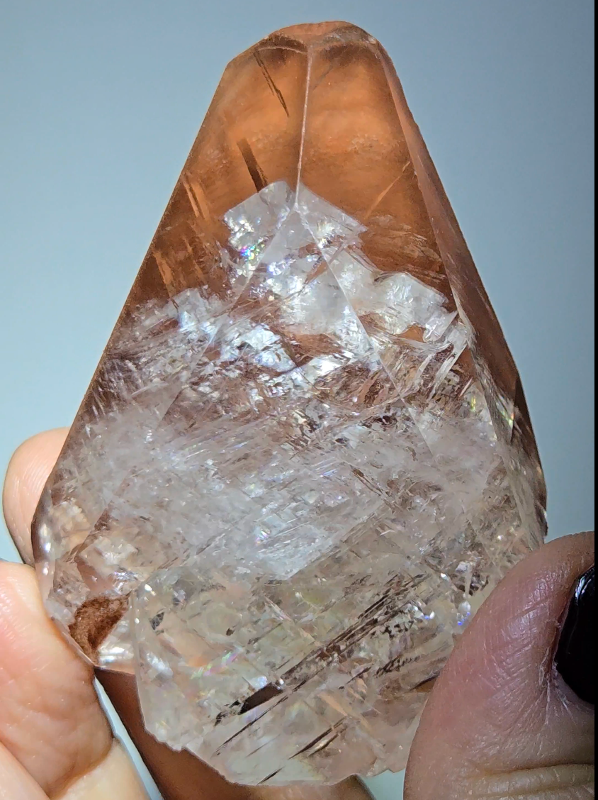 Red diamond calcite point with rainbows - CC54
