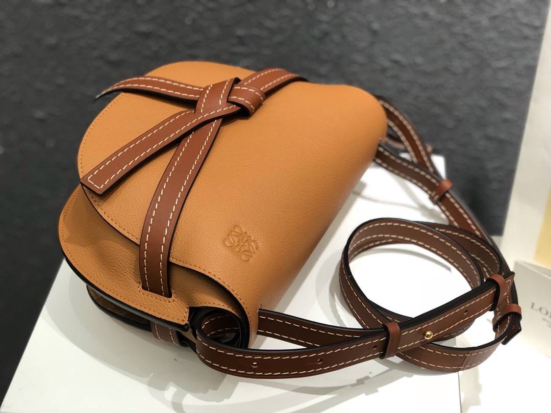 Loe❤️we专柜官网主推最新颗粒纹GATE BAG 👜蝴蝶结🎀不仅是装饰，也是包盖的唯一插口。全包只有一个带品牌精致logo 的子弹头式黄铜插鞘，没有其他五金配件，完全是高大上的西欧传统皮革工艺性和设计风格，So 自重轻便，肩带🉑️调节长度，任何身高妹纸都可驾驭，这点很nice了💃💃 👜小号尺寸:20*19*11.5cm,包身是非常柔韧的颗粒纹小牛皮，内部是麂皮，两个隔层，有一个卡袋，装得了短钱夹，手机，口红💄，气垫等，容量非常感人😇假如想带个kindel 也还是可以的哟😍😍 👜林允儿同款焦糖色，再撞个经典红棕色，包包马上upgrade ⬆️个几阶[得意]，高大上的气质感[色][色]，一眼就种草[色][色] 👜zp拆包定制，高端独家私定制五金，小牛皮，德国进口纱菲线，zp工艺，让你尊享顶级品质！ 型号:061711棕荔枝