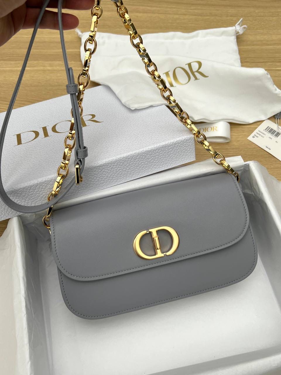 实拍实拍 💕30 MONTAIGNE AVENUE 手袋 梦幻灰色光面牛皮革 独家渠道货 独家蒙田腋下包白色珐琅扣 独家手机版实物实拍 这个实拍最接近实物颜色 尺寸：22.5 x 12.5 x 6.5 厘米